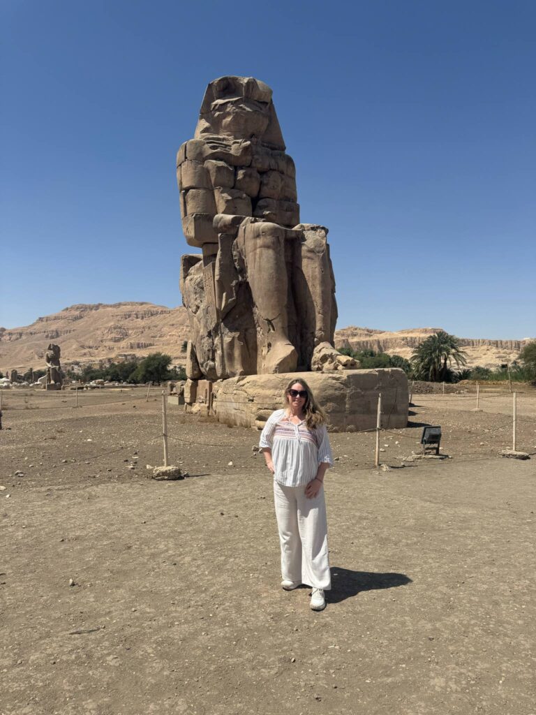 Travel Advisor Adventures by Terra standing in front of one of the Colossi of Memnon statues